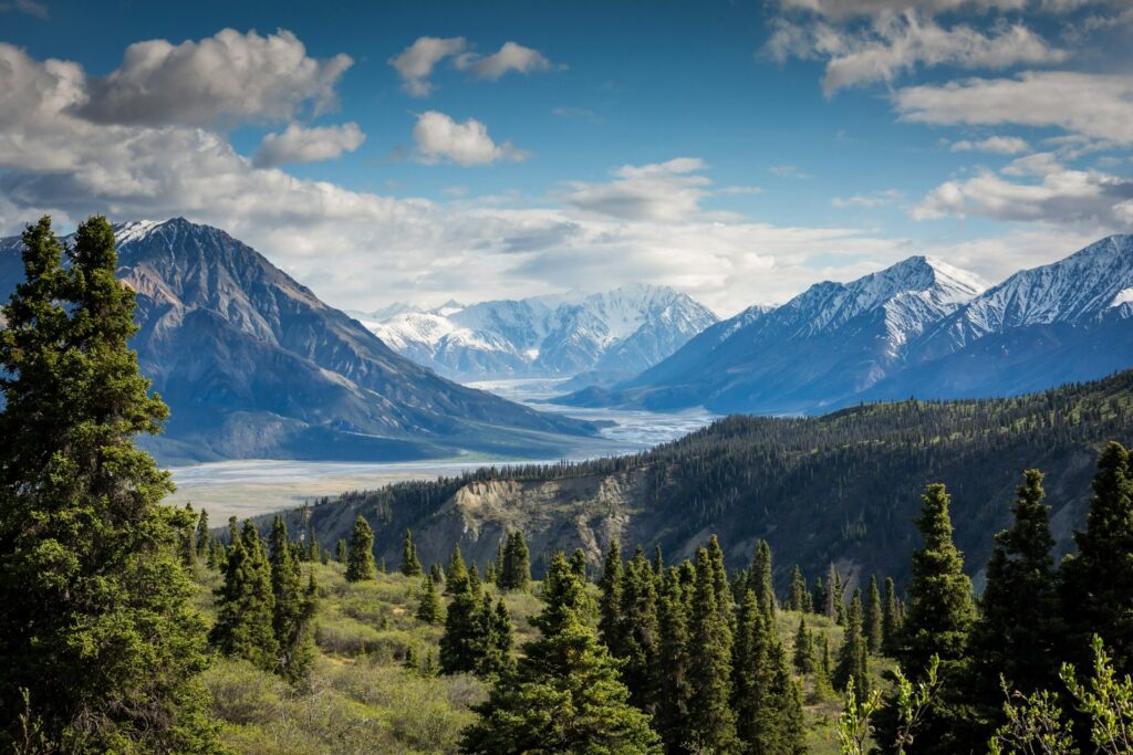 Solo hiker on a mountain ridge above clouds at sunrise